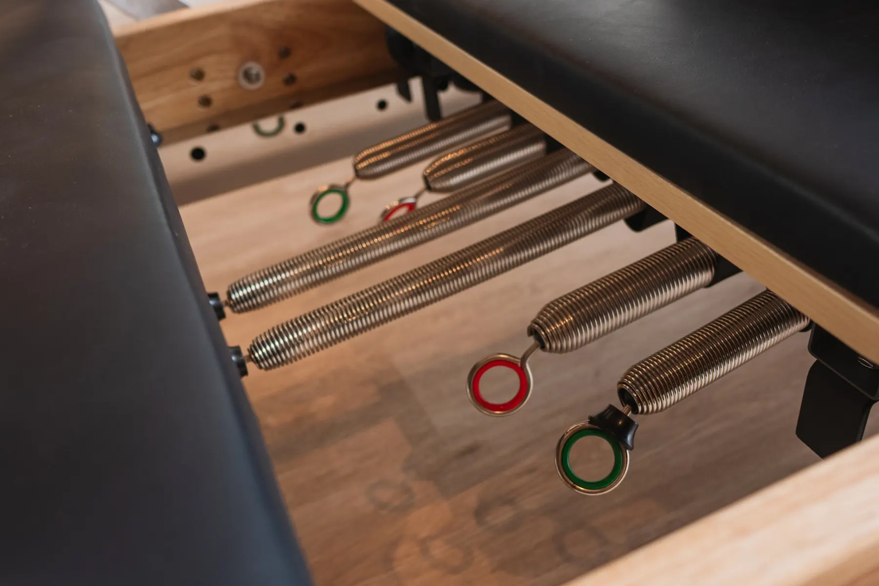 Close-up of the springs under a Pilates reformer.